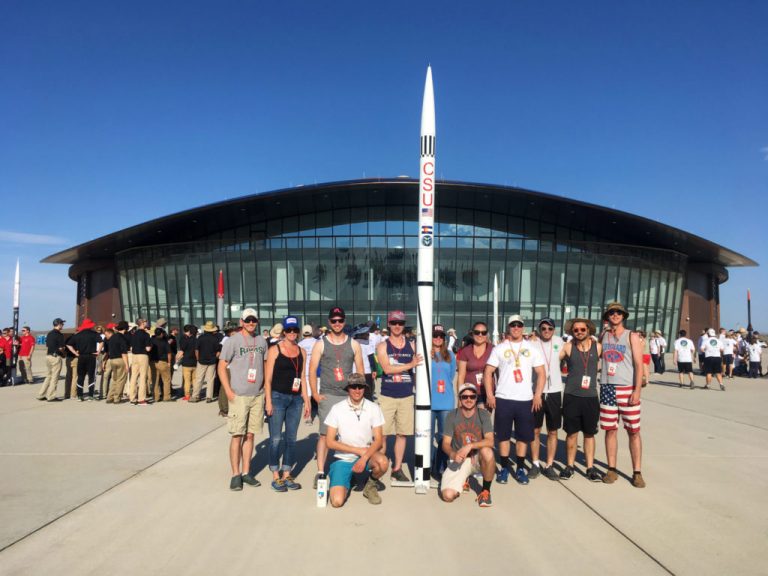 CSU Ram Rocketry Team with their liquid-fueled ARIES III rocket at the Spaceport America Cup Competition. Photo Credit: Anthony Marchese