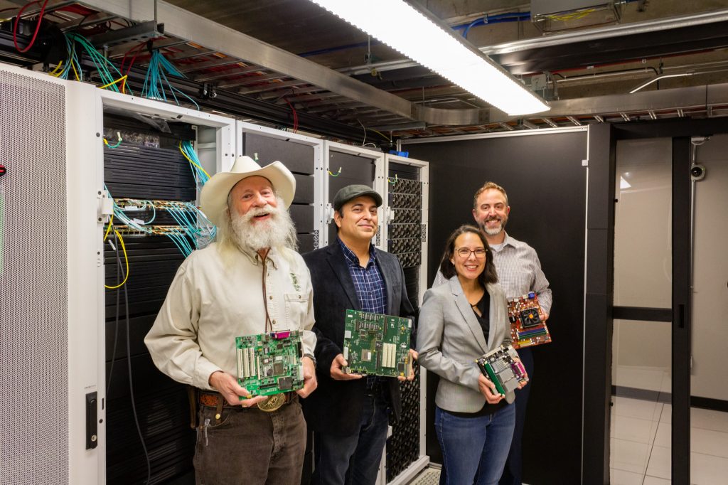 Emeritus Professor of Electrical and Computer Engineering H.J. Siegel, Electrical and Computer Engineering Professor Sudeep Pasricha, Erin Nishimura, assistant professor of Biochemistry and Molecular Biology, and Brandon Bernier, vice president of Information Technology at CSU, stand together in a server room on the Colorado State University Fort Collins campus, April 27, 2022. Credit: Russell Dickerson, Walter Scott, Jr. College of Engineering.