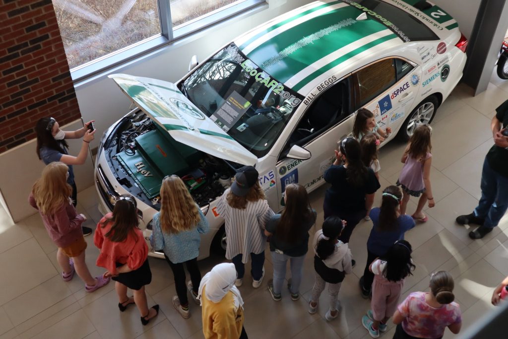 CSU Stem4Kids participants gather around the EcoCar at the CSU Powerhouse Campus.