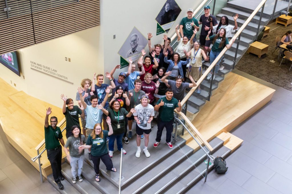 Attendees and staff of the 2022 ENcourage Math Program stand together on the stairs in the atrium of the Suzanne and Walter Scott, Jr. Bioengineering Building.