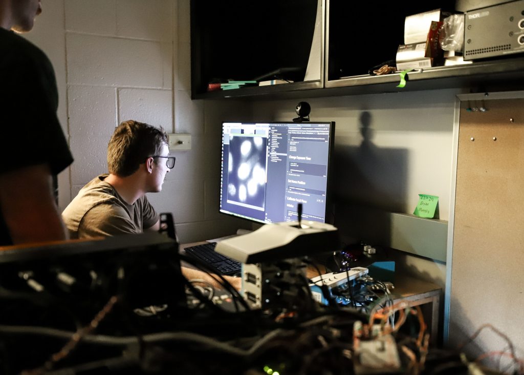 A student works on a computer in a lab.