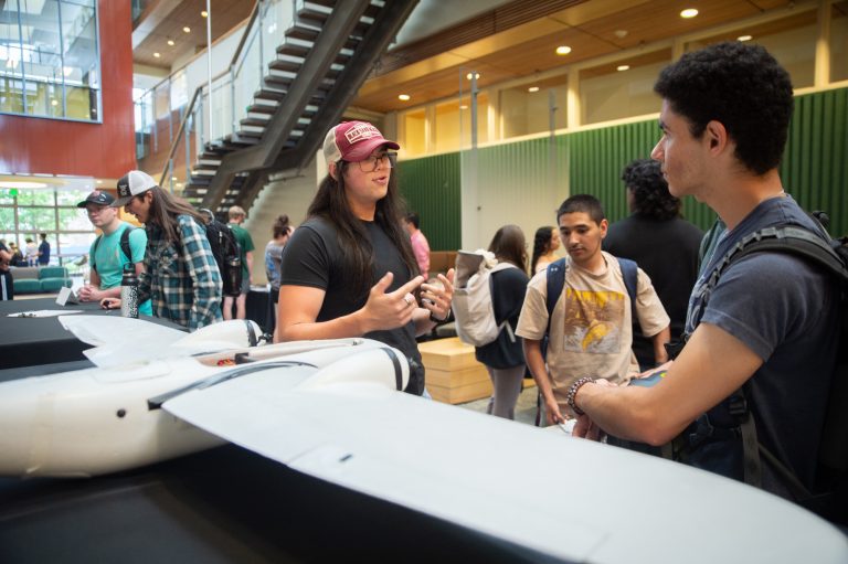 Students look at a project at the Fall 2025 student engagement fair.
