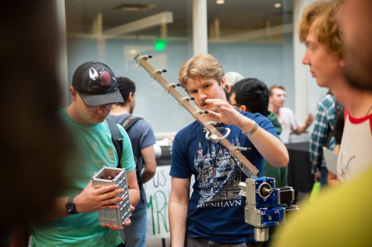 Students look at a project at the Fall 2025 student engagement fair.