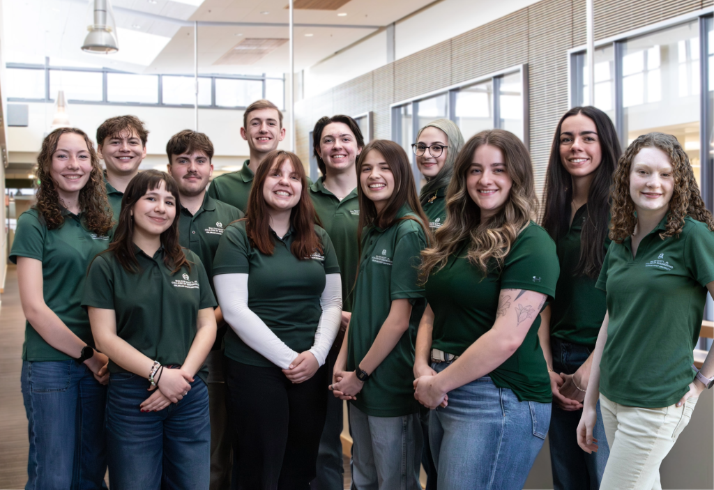 Group of students wearing green shirts.
