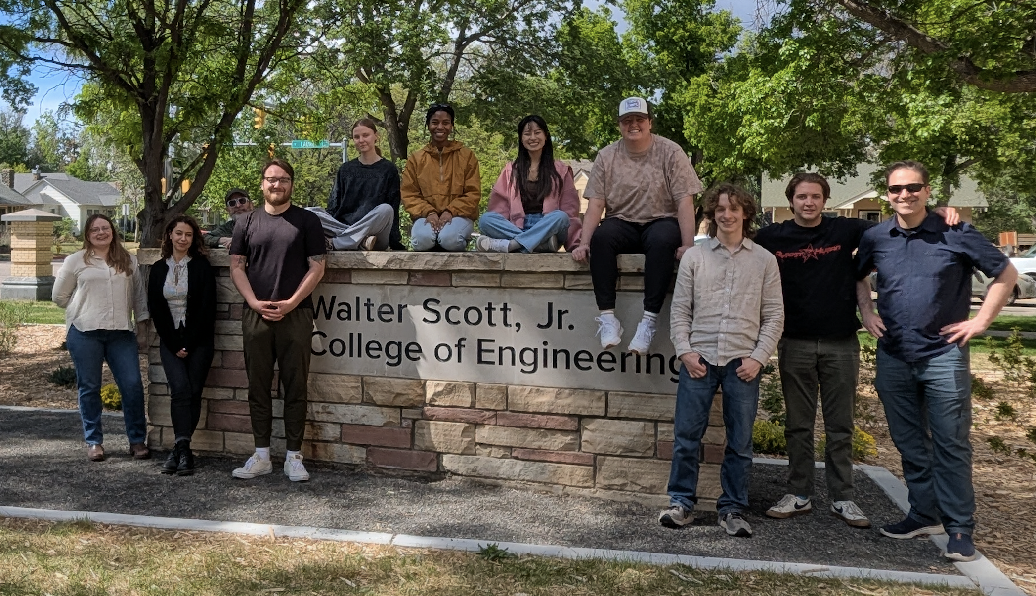 Snow Lab group photo May 2026: 11 lab members standing together - Callie, Pegah, Phil, Ethan, Rachel, Kimberly, Ashlyn, Emma, Cameron, John, Chris