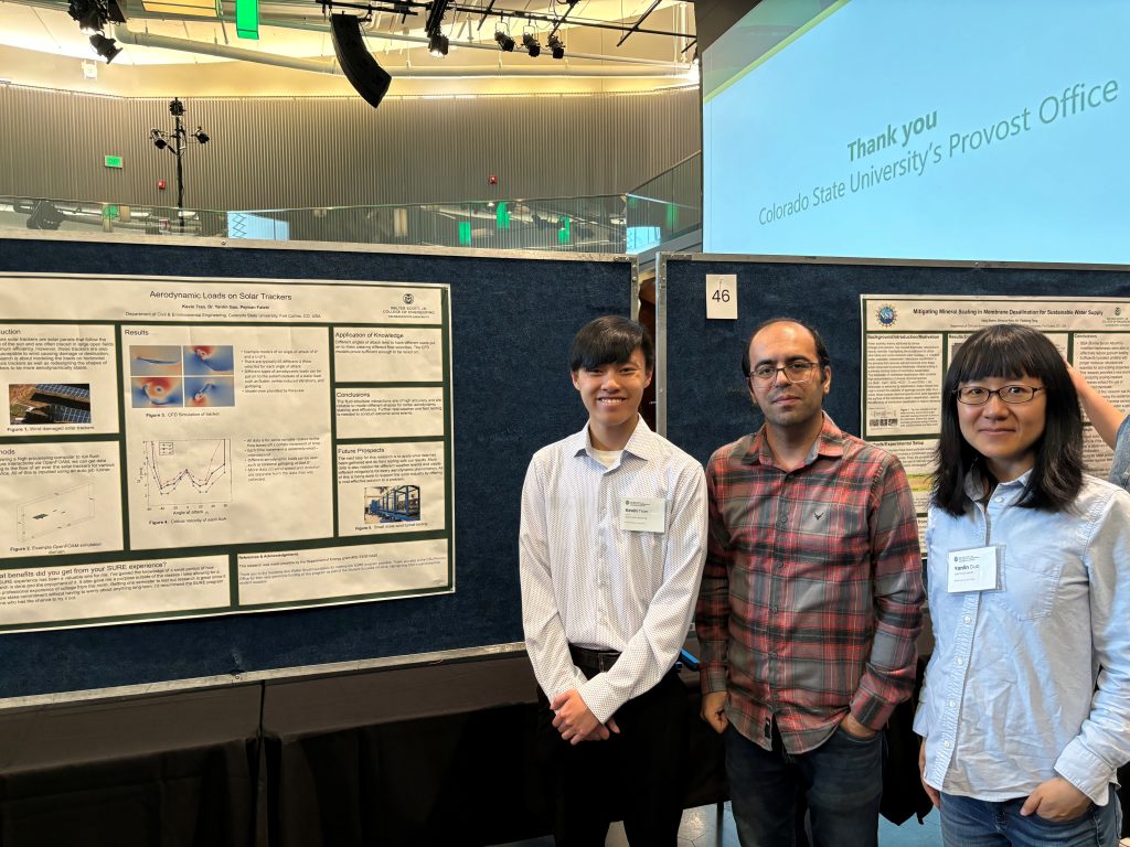 Kevin Tran standing with Dr. Guo and another researcher at poster presentation.